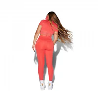 the back of a woman in orange leggings