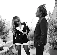 a black and white photo of a man and woman standing next to each other
